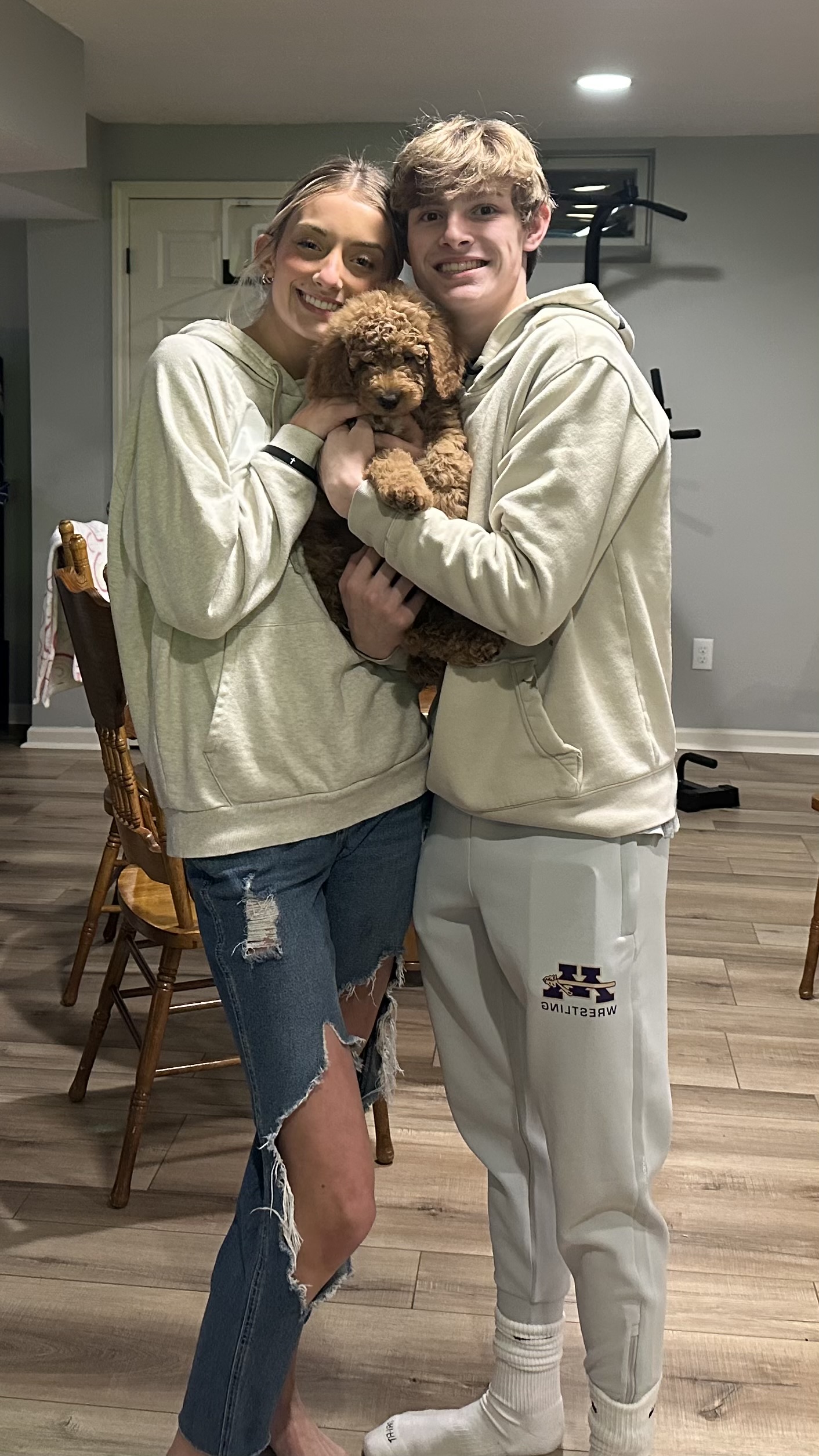 Red Goldendoodle named Honey playing with a pacifier toy